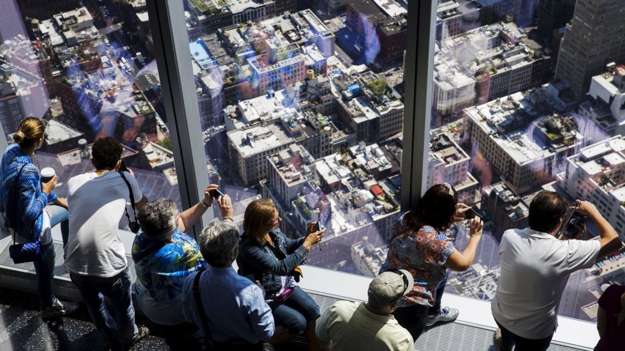 Visitors take photos from the One World Trade Center observatory, which opened to the public Friday, May 29, in New York.