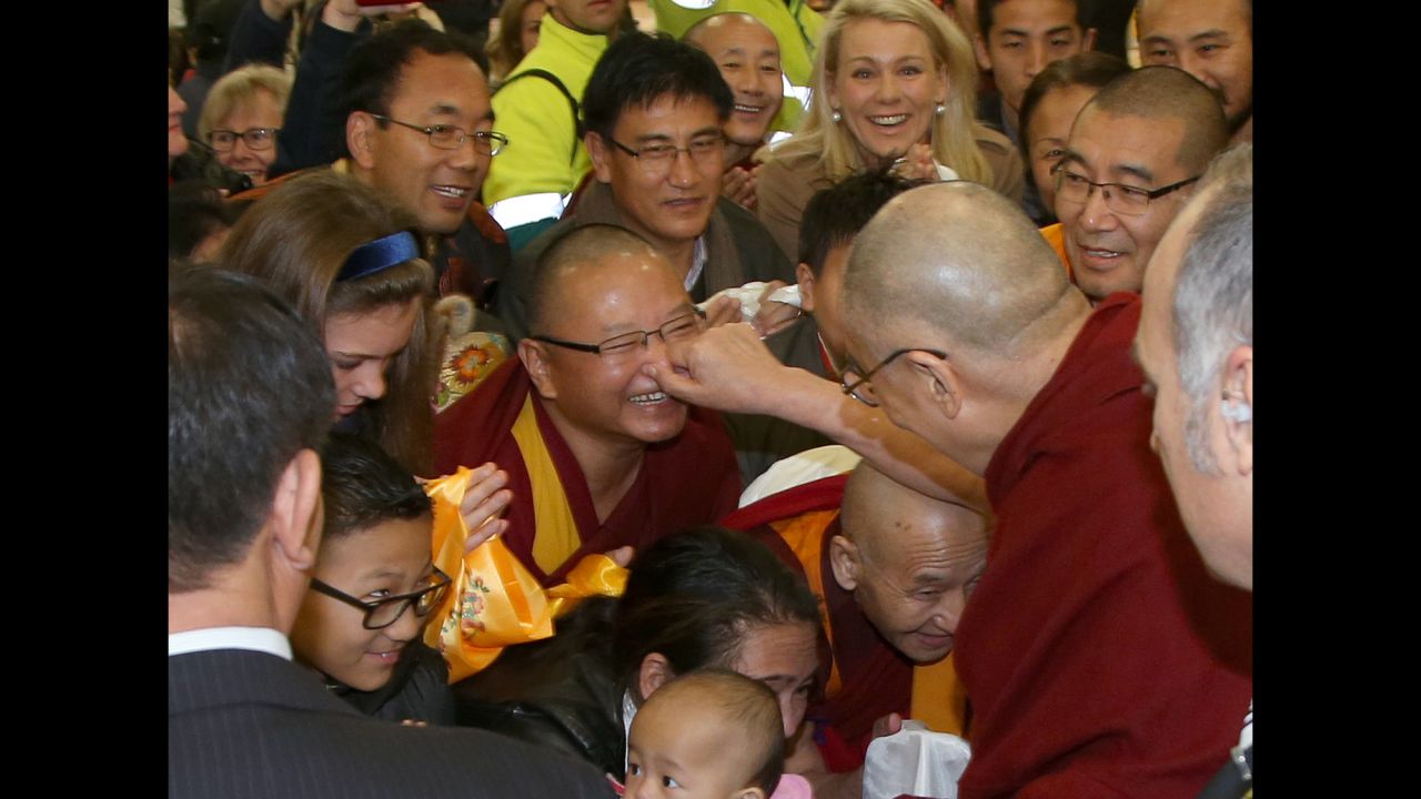 The Dalai Lama pinches the nose of a well-wisher after arriving in Sydney on Thursday, June 4. The Tibetan spiritual leader was visiting Australia for the 10th time.