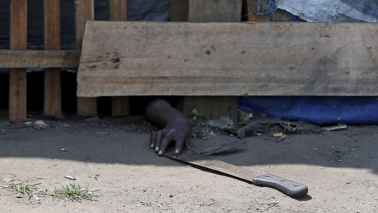 A protester hiding from police in Bujumbura, Burundi, tries to retrieve a machete during a demonstration against President Pierre Nkurunziza on Friday, May 29. <a href="http://www.cnn.com/2015/05/14/world/gallery/burundi-unrest/index.html" target="_blank">Animosity against Nkurunziza</a> boiled over in April when he expressed his intention to run for a third term. There have been demonstrations and a failed coup attempt.