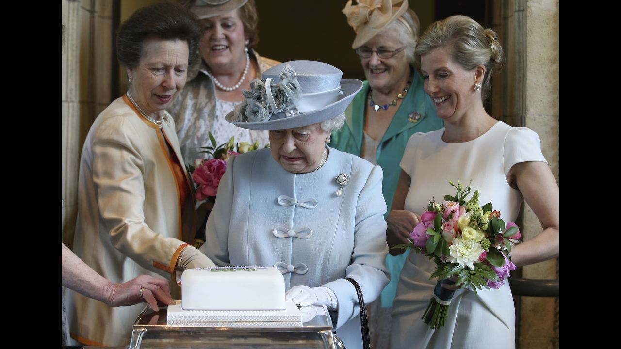 Britain's Queen Elizabeth II, center, prepares to cut a cake in London on Thursday, June 4, during the 100th annual meeting of the <a href="http://www.thewi.org.uk/about-the-wi" target="_blank" target="_blank">National Federation of Women's Institutes</a>. On the left is Elizabeth's daughter, Princess Anne, and on the right is Elizabeth's daughter-in-law Sophie, Countess of Wessex.