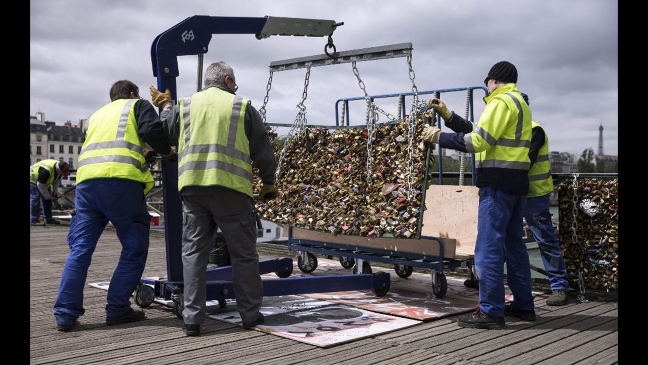 Paris city employees remove a railing loaded with locks on the Pont des Arts bridge on Tuesday, June 2. For years, couples have put locks on the bridge to symbolize their affection -- a tradition often followed by throwing the key into the Seine River below. <a href="http://www.cnn.com/2015/05/30/travel/gallery/paris-love-locks/index.html" target="_blank">But the city decided to remove the padlocks </a>because sections of the bridge's fencing started crumbling under the locks' weight.