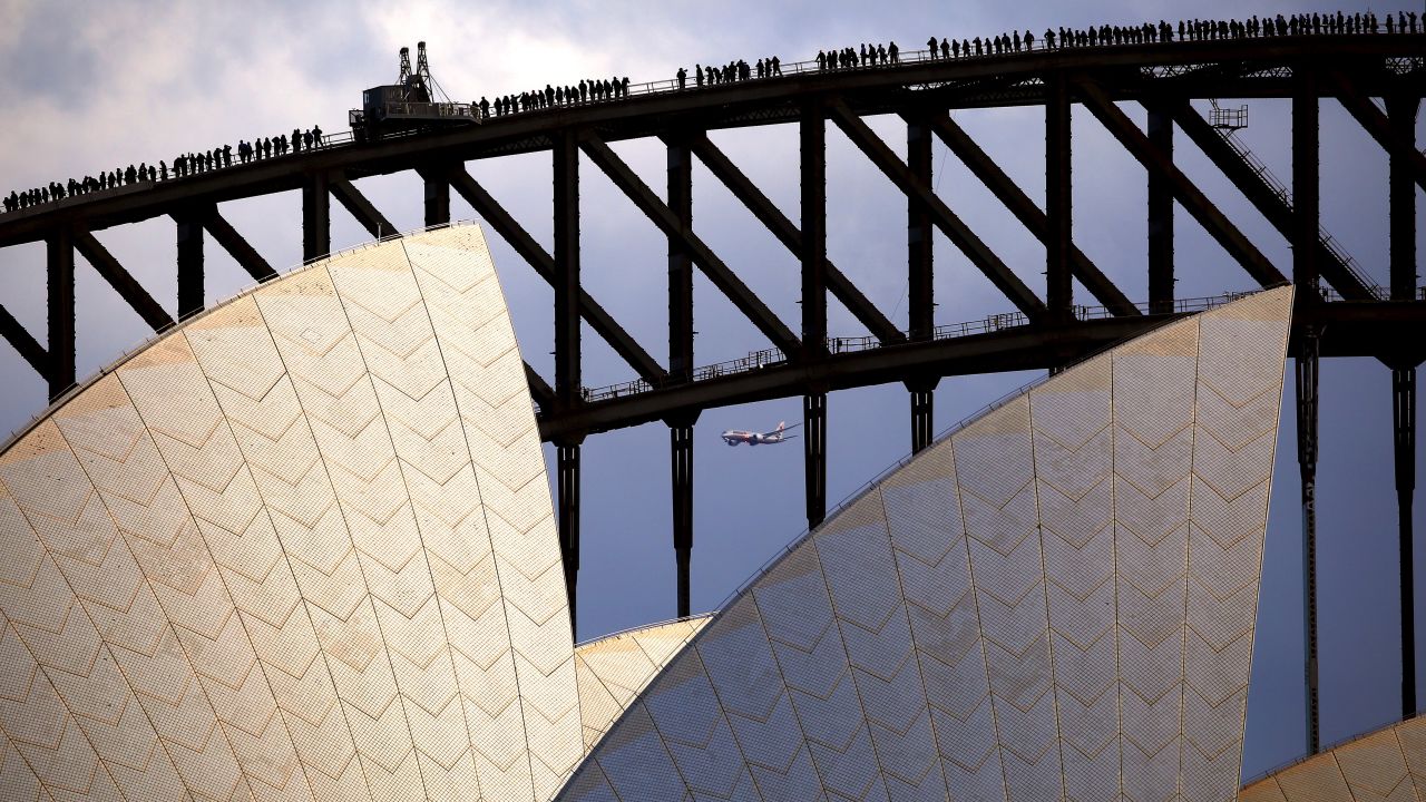 Delegates from the inaugural <a href="http://www.australiachina.org" target="_blank" target="_blank">China Australia Millennial Project Summit</a> stand atop the Sydney Harbour Bridge, above the roof of the Sydney Opera House, on Monday, June 1.
