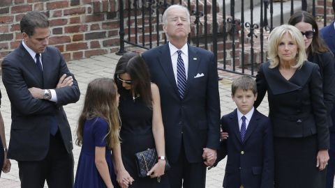 Joe Biden pauses with his family as they enter the visitation. 