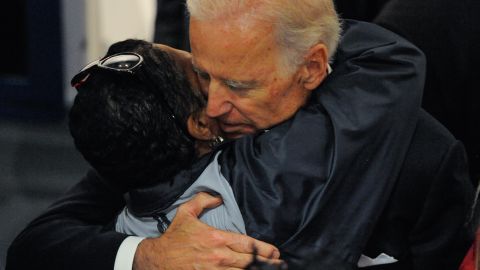 Biden hugs a woman while waiting in line to view his son's body.