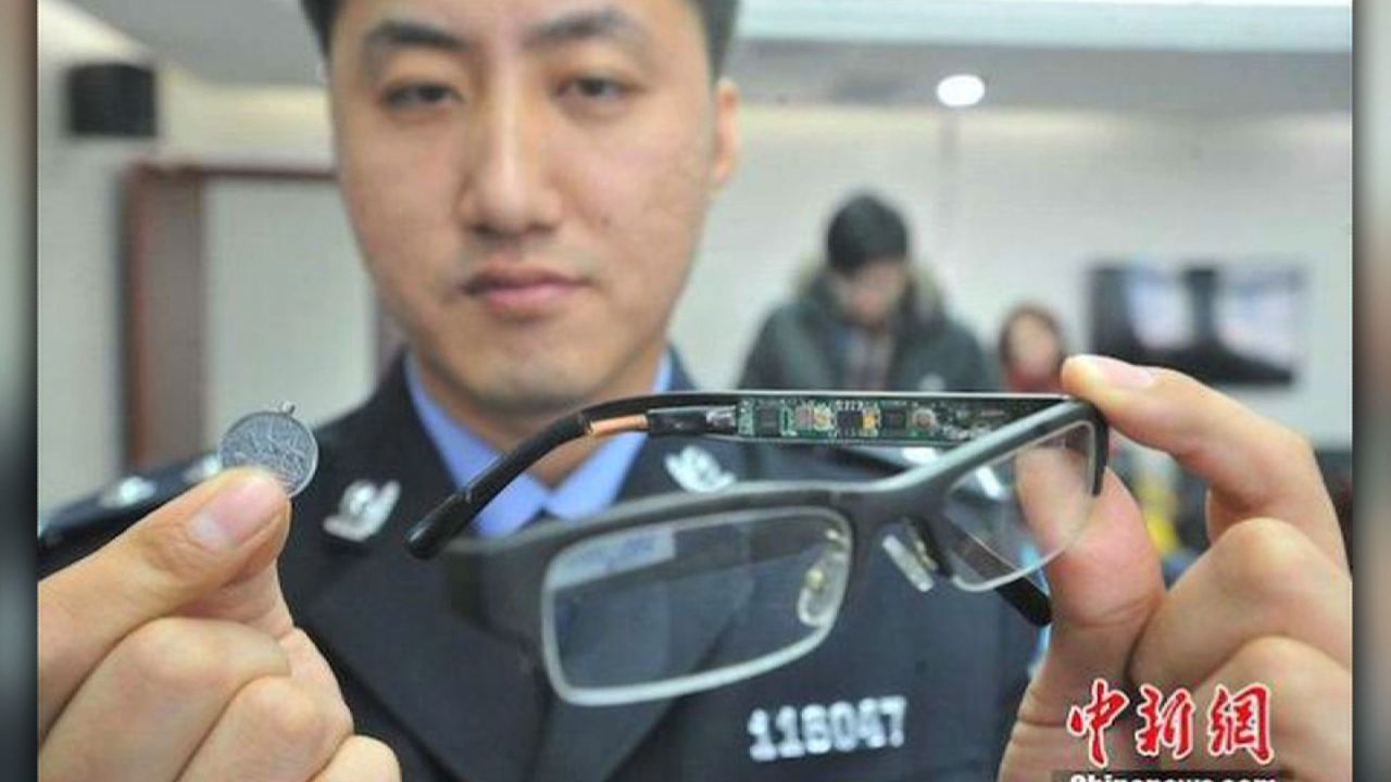 The stakes are so high some students have stooped to ingenious methods of cheating.  A police officer displays a device used by students to cheat in previous years.