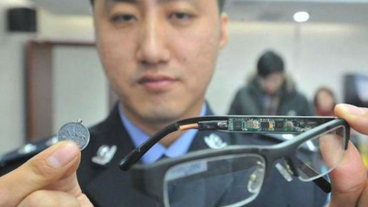 A police officer displays a device used by students to cheat in previous years. 