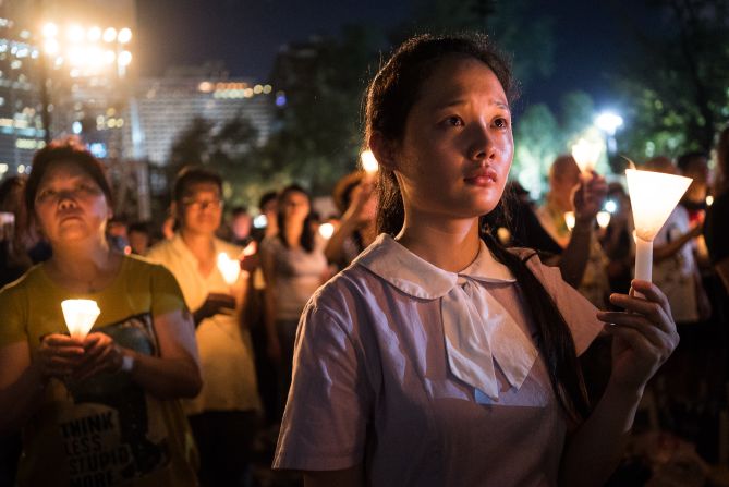 A student raises a candle at a vigil in Hong Kong on Thursday, June 4, 2015. Tens of thousands of people attended the service in remembrance of <a href="index.php?page=&url=http%3A%2F%2Fwww.cnn.com%2F2014%2F06%2F01%2Fasia%2Fgallery%2Ftiananmen-crackdown-timeline%2Findex.html" target="_blank">the 1989 Tiananmen Square protests.</a> The vigil is held annually at Victoria Park, but this year's gathering took on greater meaning after <a href="index.php?page=&url=http%3A%2F%2Fwww.cnn.com%2F2014%2F09%2F22%2Fasia%2Fgallery%2Fhong-kong-students-protest%2Findex.html" target="_blank">last year's pro-democracy protests.</a>