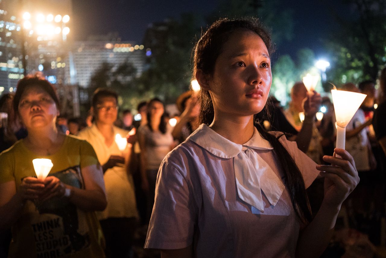 A student raises a candle at a vigil in Hong Kong on Thursday, June 4, 2015. Tens of thousands of people attended the service in remembrance of <a href="http://www.cnn.com/2014/06/01/asia/gallery/tiananmen-crackdown-timeline/index.html" target="_blank">the 1989 Tiananmen Square protests.</a> The vigil is held annually at Victoria Park, but this year's gathering took on greater meaning after <a href="http://www.cnn.com/2014/09/22/asia/gallery/hong-kong-students-protest/index.html" target="_blank">last year's pro-democracy protests.</a>