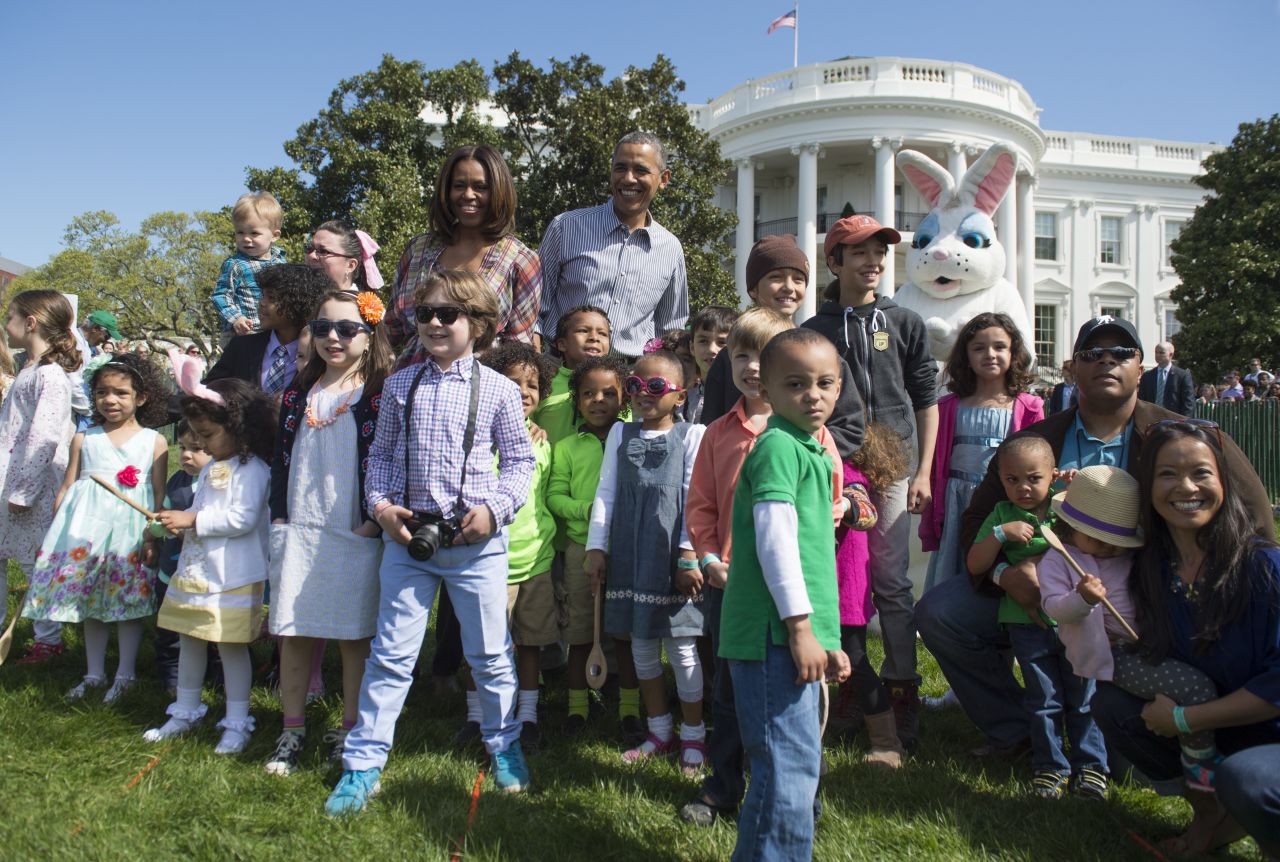 Obama and first lady Michelle Obama greet children during the White House Easter Egg Roll in April 2014.