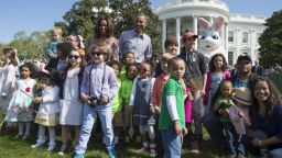 Obama and First Lady Michelle Obama greet children during the annual White House Easter Egg Roll on the South Lawn of the White House in Washington, DC, April 21, 2014.