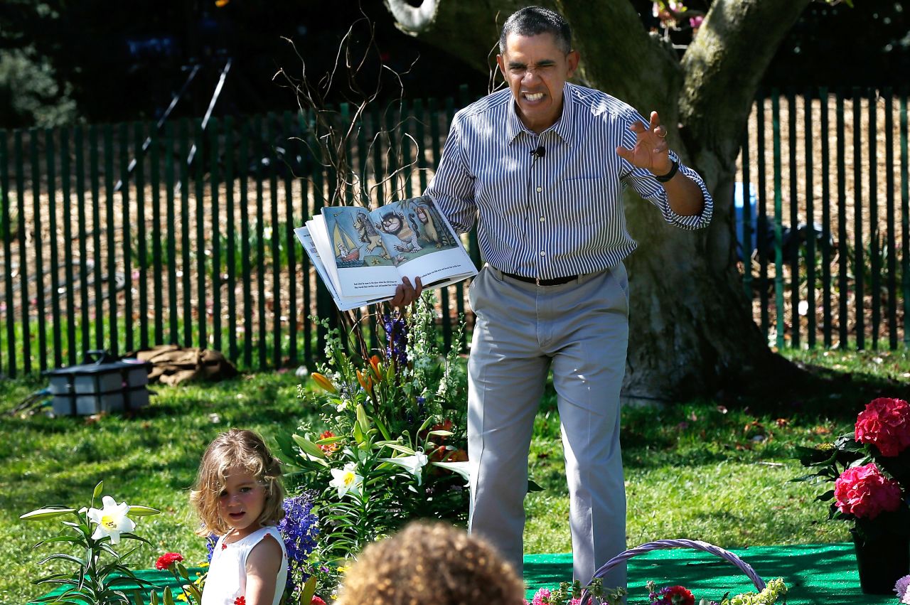 Obama reads to children from the book "Where the Wild Things Are" by Maurice Sendak during the White House Easter Egg Roll in April 2014.
