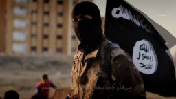 An English-speaking ISIS fighter orchestrates the mass execution of a group of men in an ISIS recruitment video called "Flames of War."