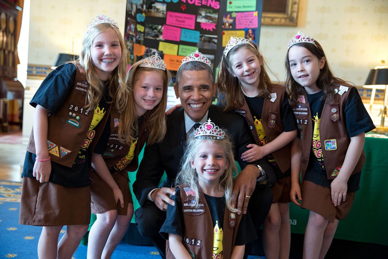 Obama poses with a Girl Scout Brownie from Tulsa, Oklahoma, after they showed off a science fair exhibit, a flood-proof bridge made of Legos.