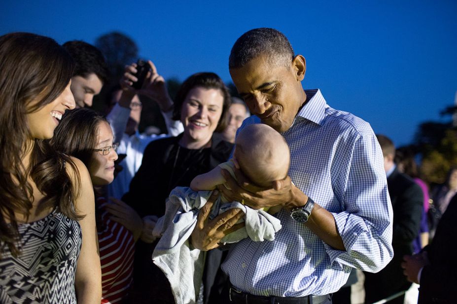 Obama holds a baby during the Congressional Picnic at the White House in September.