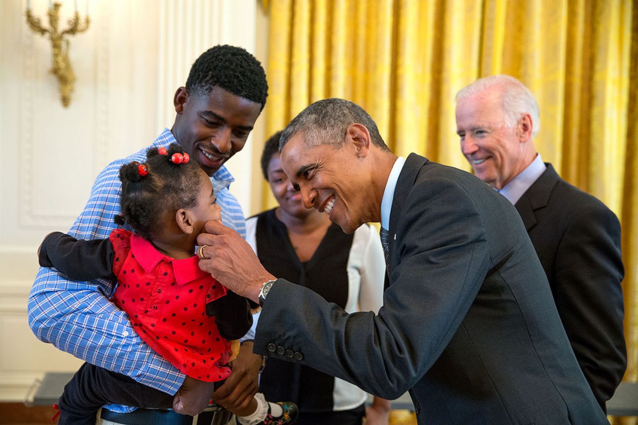 Obama greets a child during a tour of the White House in September.