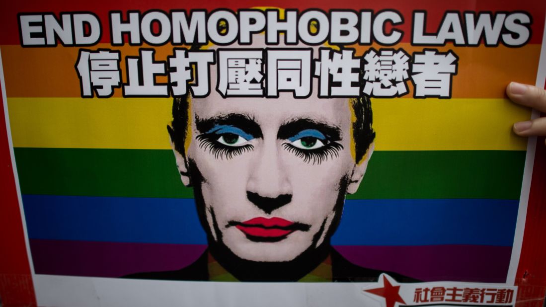 An activist in Hong Kong holds a placard with a slogan over the face of Russian President Vladimir Putin during a demonstration against Russia's anti-gay legislation on the day of the opening ceremony of the Sochi Winter Olympic Games in February, 2014.