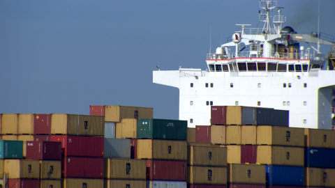 A barge filled with shipping containers.
