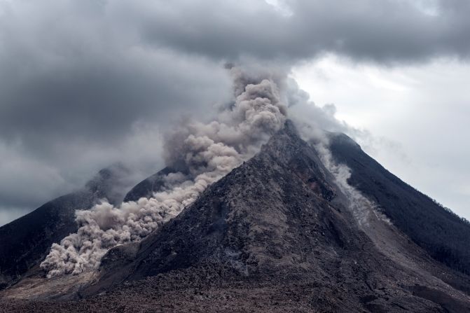 Thick ash, rock fragments and volcanic gases pour from <a href="index.php?page=&url=http%3A%2F%2Fireport.cnn.com%2Fdocs%2FDOC-1246978">Mount Sinabung</a> in Indonesia. The government's natural disaster management agency raised the alert level on June 5, 2015.