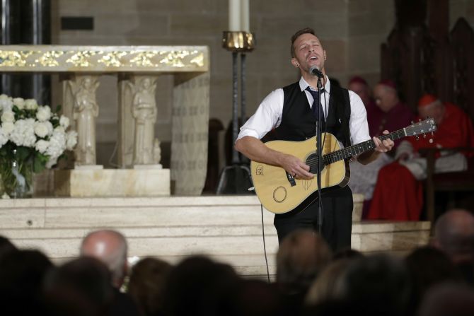 Chris Martin of Coldplay performs "Til Kingdom Come" during the funeral. 