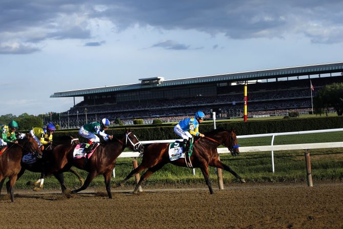 American Pharoah leads the field entering turn three.