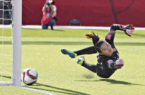 Chinese goalkeeper Wang Fei tries in vain to stop a penalty kick by Canada's Christine Sinclair. The goal came late in second-half stoppage time.