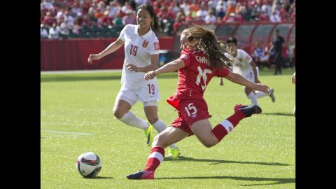 Canada's Allysha Chapman looks to cross the ball as China's Tan Ruyin defends.