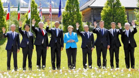 Members of the G7 pose for their group photo. From left to right: President of the European Council Donald Tusk, Japanese Prime Minister Shinzo Abe, Canada's Prime Minister Stephen Harper, U.S. President Barack Obama, German Chancellor Angela Merkel, French President Francois Hollande, British Prime Minister David Cameron, Italian Prime Minister Matteo Renzi and President of the European Commission Jean-Claude Juncker.