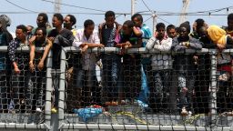 Migrants wait to disembark from the German Navy ship Hessen at the Palermo harbor, Italy, Sunday, June 7. European rescue boats are bringing thousands of migrants saved at sea to Italian ports.