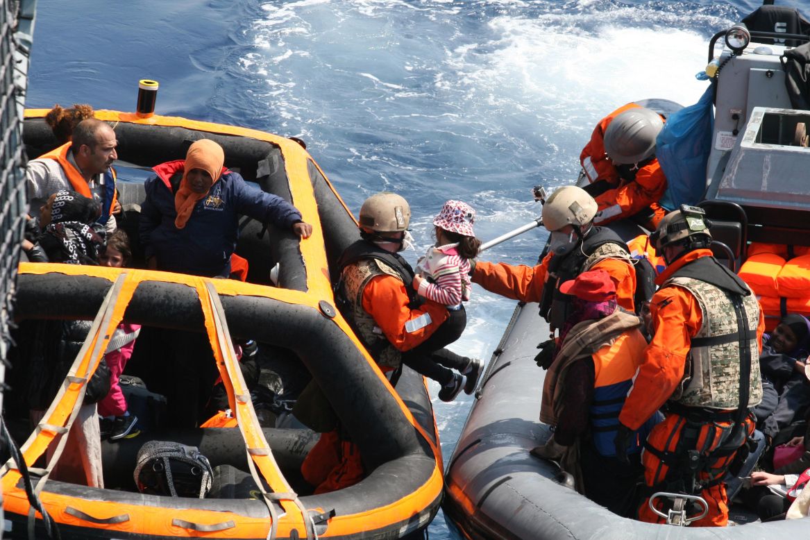 Soldiers from the German frigate Hessen help refugees in the Mediterranean on Saturday, June 6. 