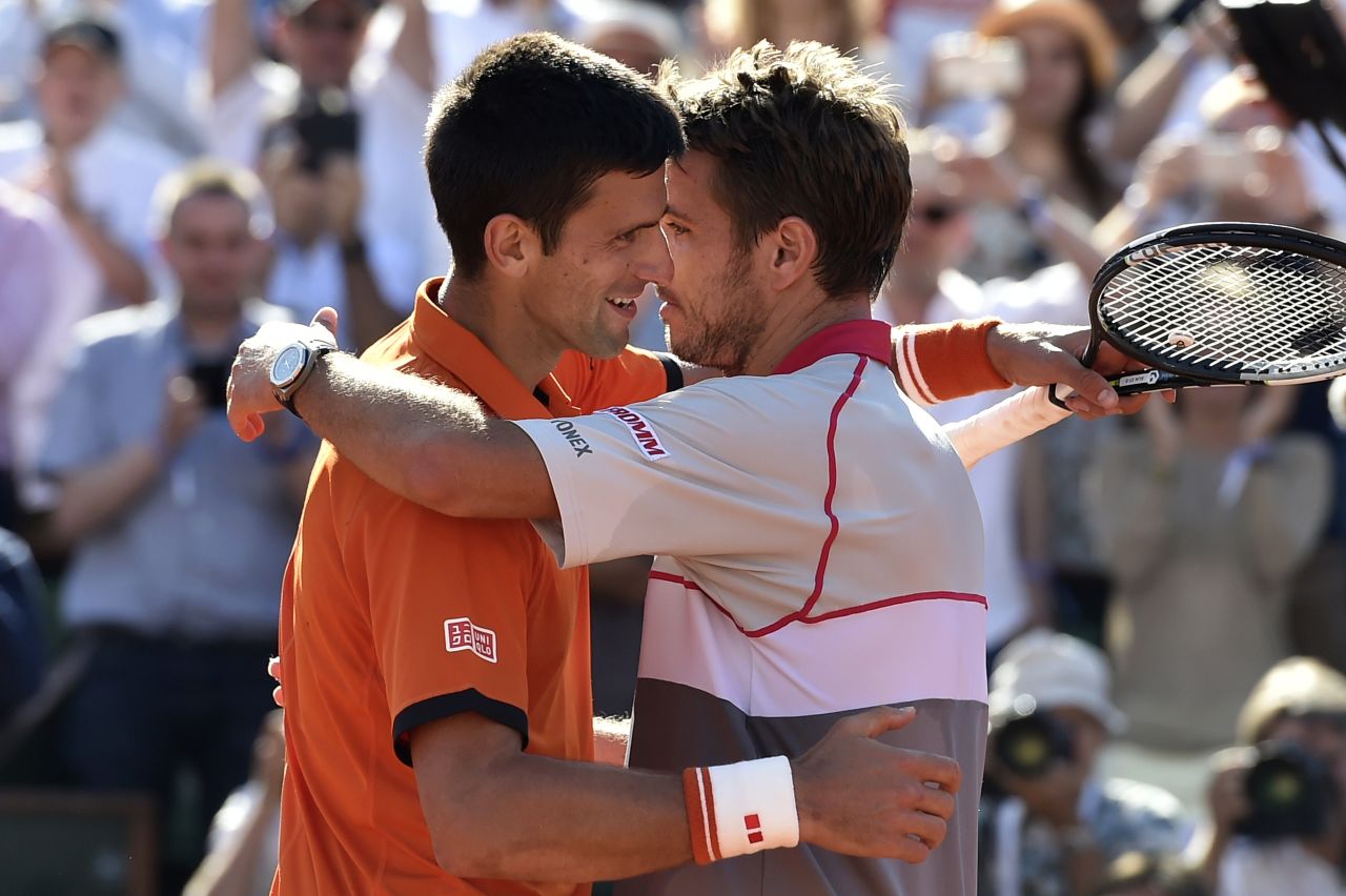 The two finalists sportingly embrace at the net after Wawrinka's upset victory over the world number one Djokovic. 