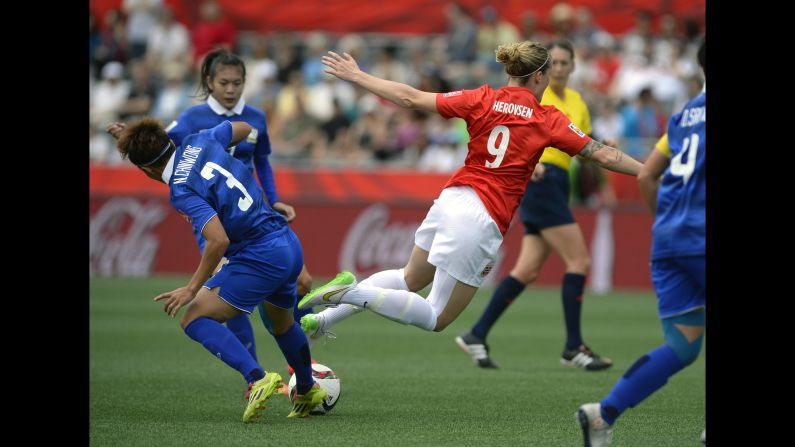 Norway's Isabell Herlovsen falls after a challenge from Thailand's Natthakarn Chinwong on Sunday, June 7. Herlovsen scored two goals as Norway defeated Thailand 4-0.