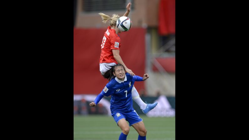 Norway's Lene Mykjaland, top, battles Thailand's Silawan Intamee for the ball.