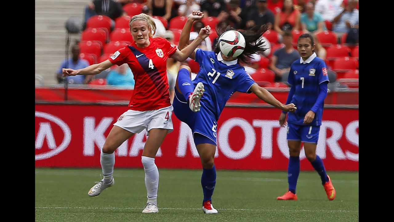 Norway's Gry Tofte Ims, left, competes against Kanjana Sung-Ngoen of Thailand.