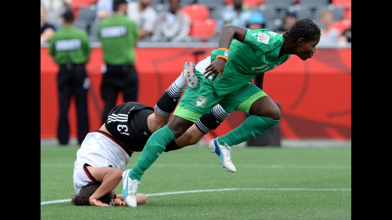 Germany's Celia Sasic falls head first into the turf after a collision with Ivory Coast's Sophie Aguie on Sunday, June 7. Germany defeated Ivory Coast 10-0 in Ottawa.
