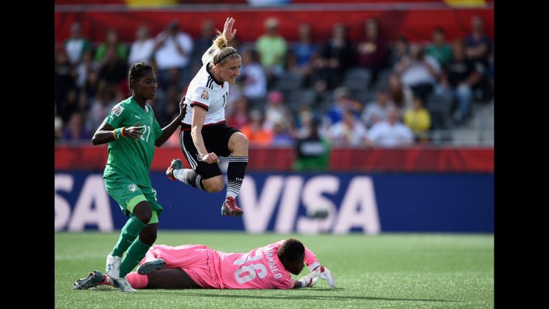 Germany's Anja Mittag, top, reacts while scoring the sixth goal of the match.