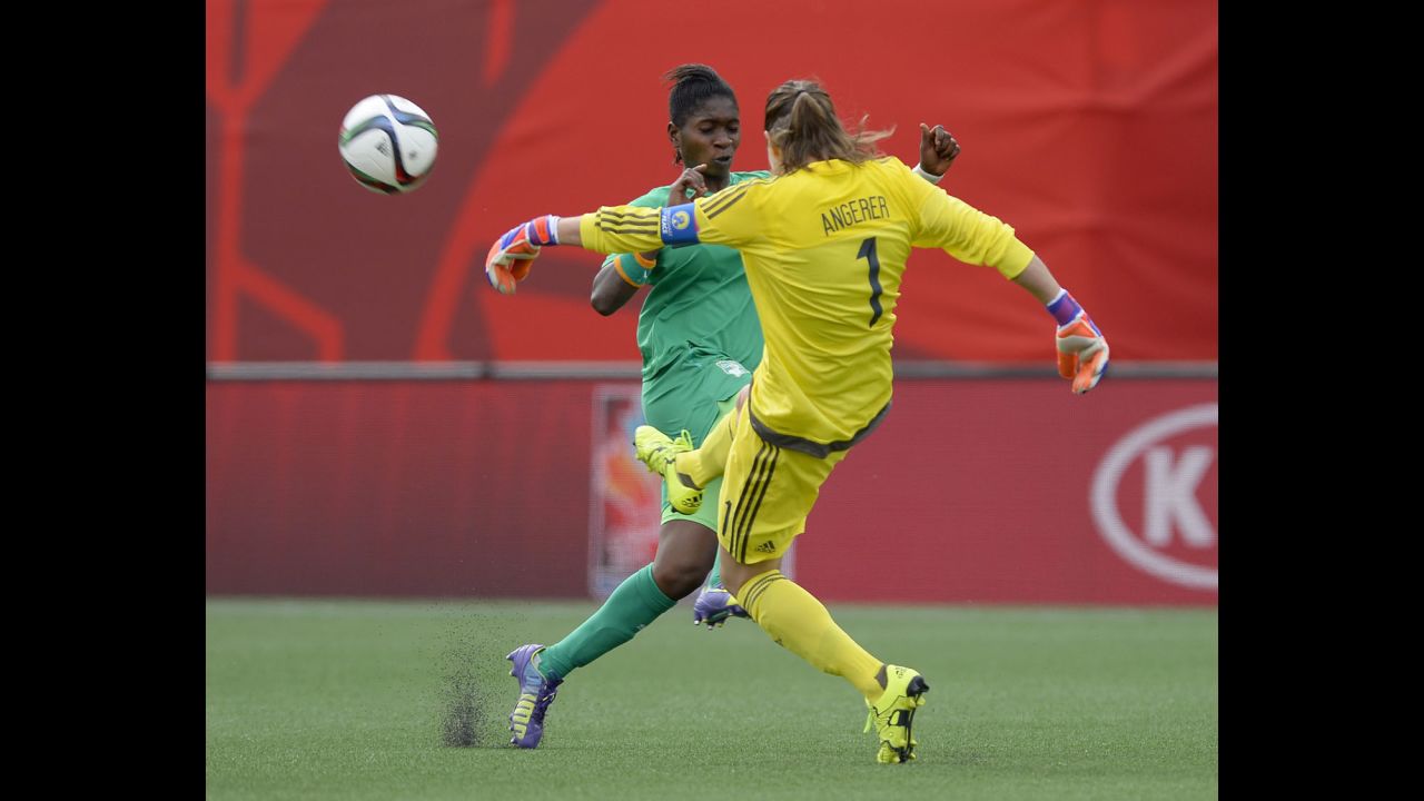 Germany goalkeeper Nadine Angerer kicks the ball away as Ivory Coast's Rebecca Elloh makes a challenge.