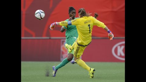 Germany goalkeeper Nadine Angerer kicks the ball away as Ivory Coast's Rebecca Elloh makes a challenge.