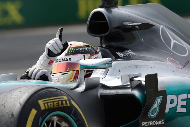 Hamilton makes it win number three in Montreal -- one of his favorite GP venues. Here, he signals victory at the Canadian GP where he beat Mercedes teammate Nico Rosberg.