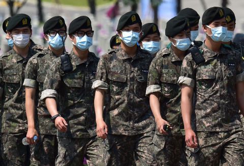 South Korean soldiers wear face masks as they march after a ceremony marking the 60th anniversary of Korean Memorial Day at the National Cemetery in Seoul on June 6, 2015.