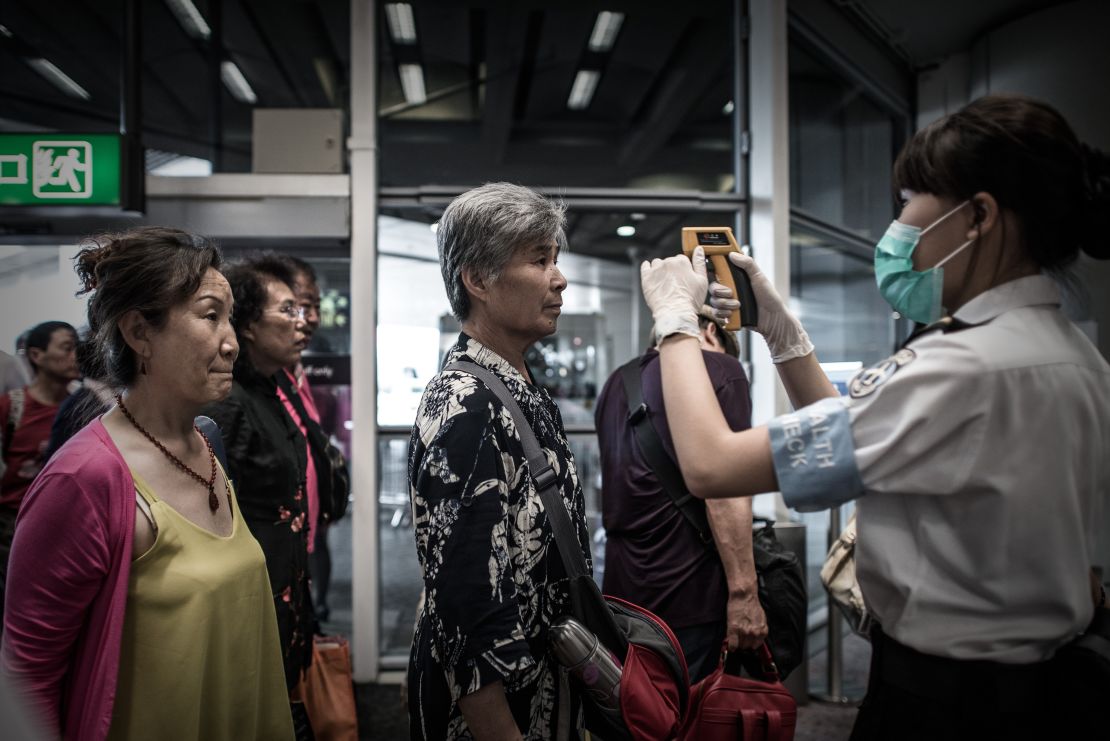Passengers get their temperature checked in 2015 as part of preventive measures against the spread of MERS at Hong Kong airport.