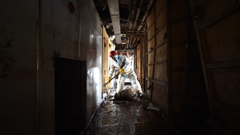A worker clears a hallway of the ship on June 8.