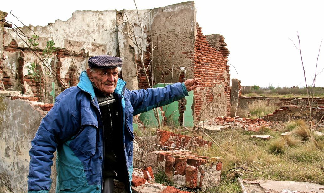 After being buried under 33 feet of floodwater for about 25 years, Epecuen re-emerged in 2009. Novak points at the ruins of his primary school.