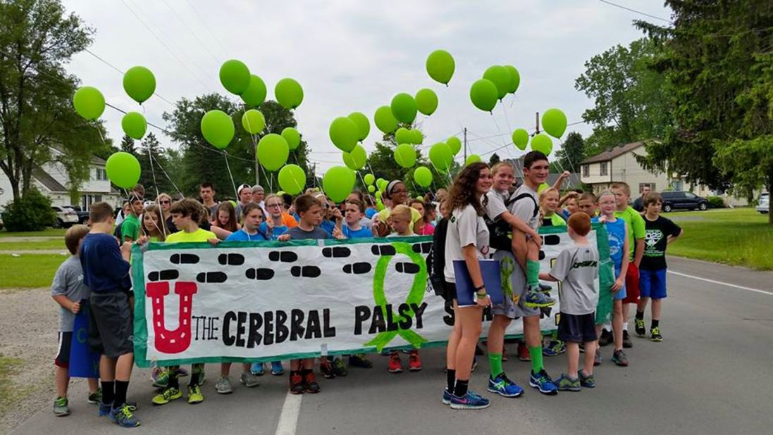 Michigan teen Hunter Gandee carried his little brother Braden 57 miles across Michigan to raise awareness of cerebral palsy, which Braden has. Students from Braden's elementary school in Lambertville, Michigan, joined Hunter to start the walk.