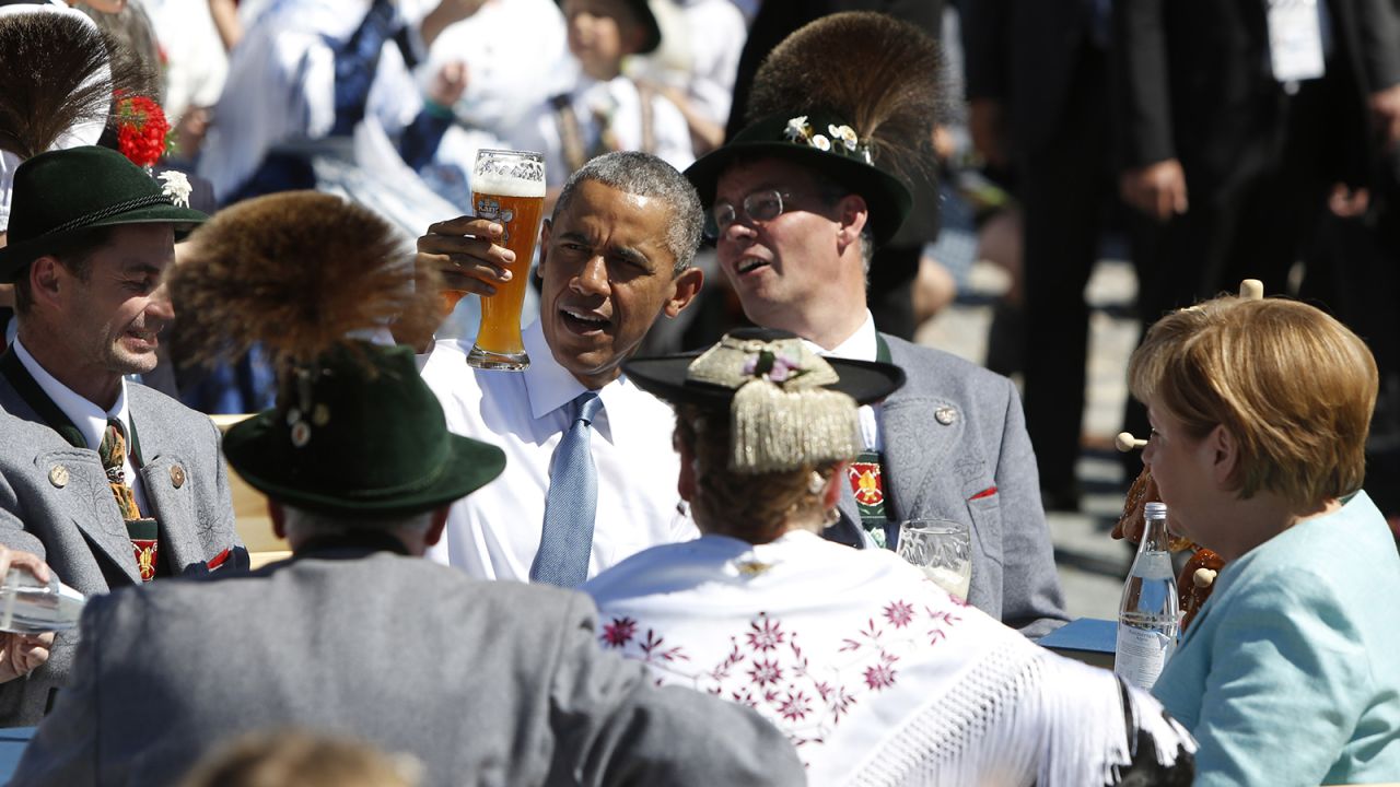 Obama enjoys a beer with Merkel, right, at the summit of G7 nations on June 7 in Kruen, Germany.