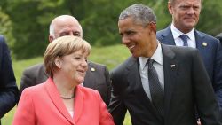German Chancellor Angela Merkel and U.S. President Barack Obama chat during the outreach group photo on the second day of the summit of G7 nations at Schloss Elmau on June 8, 2015, near Garmisch-Partenkirchen, Germany.