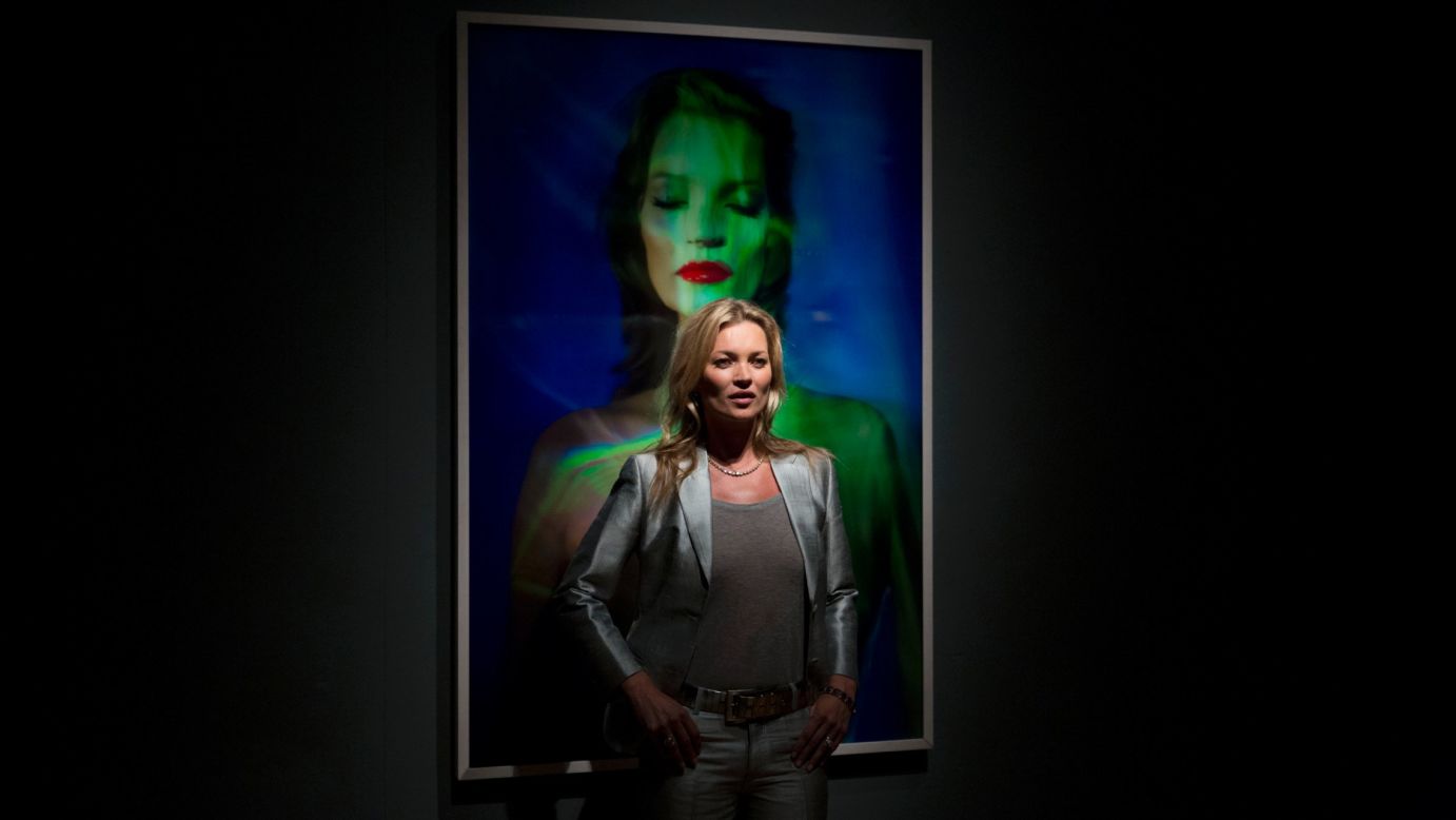 Moss has inspired the creativity of many artists. Here, she poses beside "She's Light (Laser 3)" by Chris Levine at Christie's Auction House in London in September 2013.