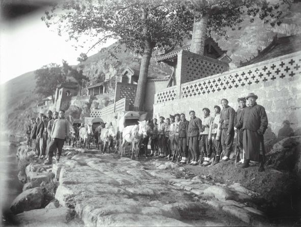 Here, a team of assistants are photographed during art collector and founder of the Freer Gallery, Charles Freer's, last expedition to China in 1910.<br />"On this trip, Freer's goal was to visit the Buddhist cave temple complex at Longmen Gorge in Henan province. One of China's great cultural monuments, Longmen has more than 1,000 man-made caves, many containing masterpieces of stone sculpture dating from the 5th to 9th century," explained the Freer Gallery.<br />"Chinese officials insisted that an armed guard accompany Freer. When he set out from Luoyang, his party had grown to more than 20 people, including porters, a cook, a photographer, and six soldiers," the gallery said of this intriguing snapshot.