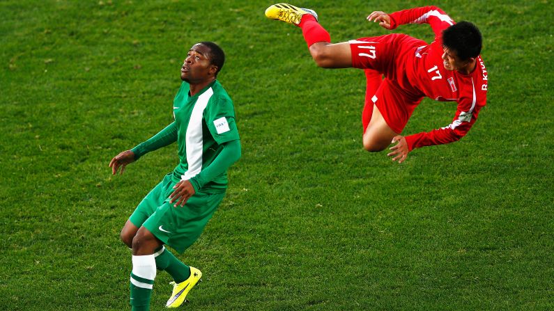 North Korean soccer player Ri Kyong Jin goes flying through the air as he is challenged by Nigeria's Mustapha Abdullahi during an Under-20 World Cup match on Thursday, June 4.