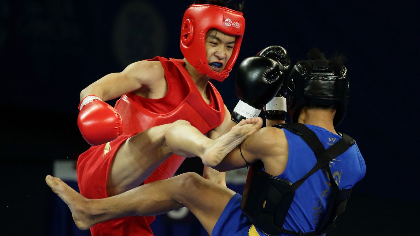 Singapore's Lee Aik Hong, left, fights Myanmar's Ko Chit Ko at the Southeast Asian Games on Saturday, June 6. Ko won the bout 2-0 and advanced to the quarterfinals of his weight class.
