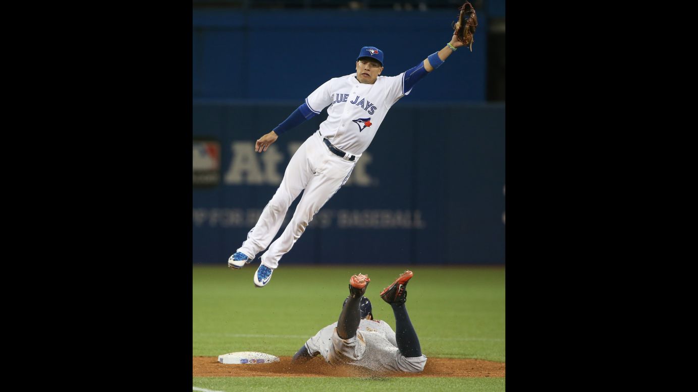 Toronto's Ryan Goins jumps for a high throw as Houston's George Springer steals second base on Friday, June 5.